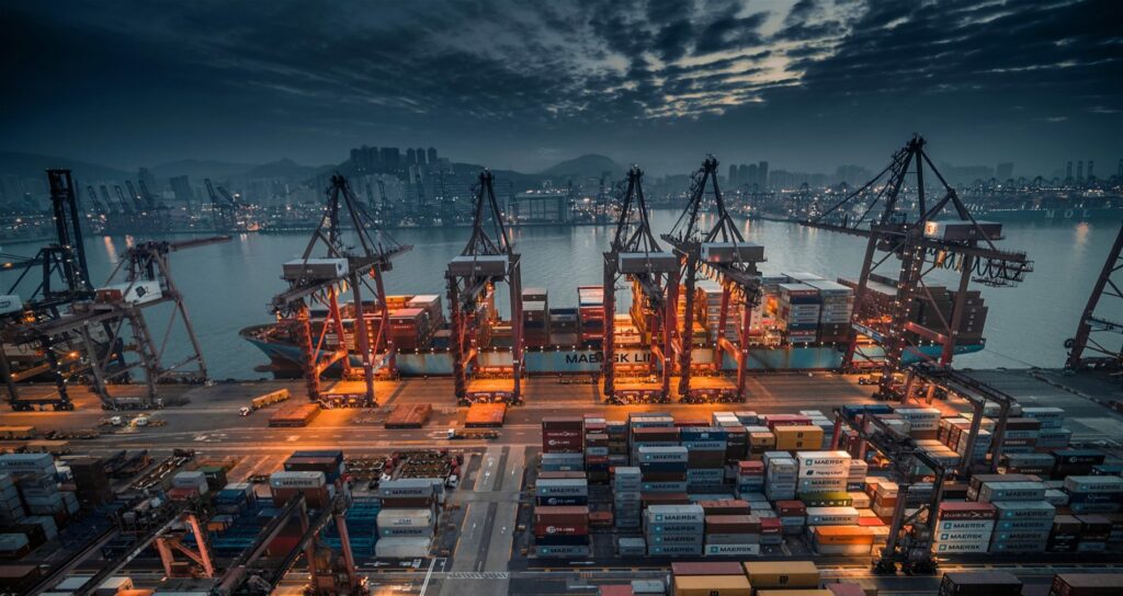 Gantry cranes at dusk, a vessel alongside